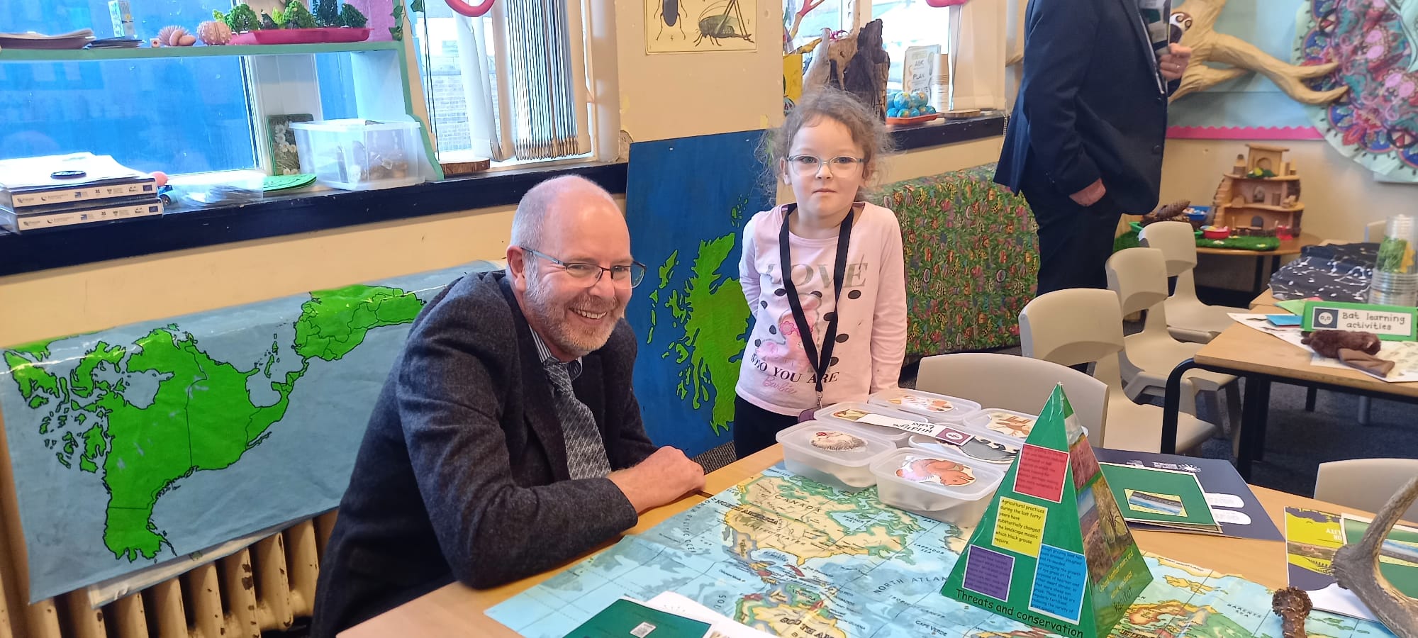 Molly, a pupil at Girvan Primary School, shows the Galloway and Southern Ayrshire Biosphere's Director, Ed Forrest, her nature-based learning projects