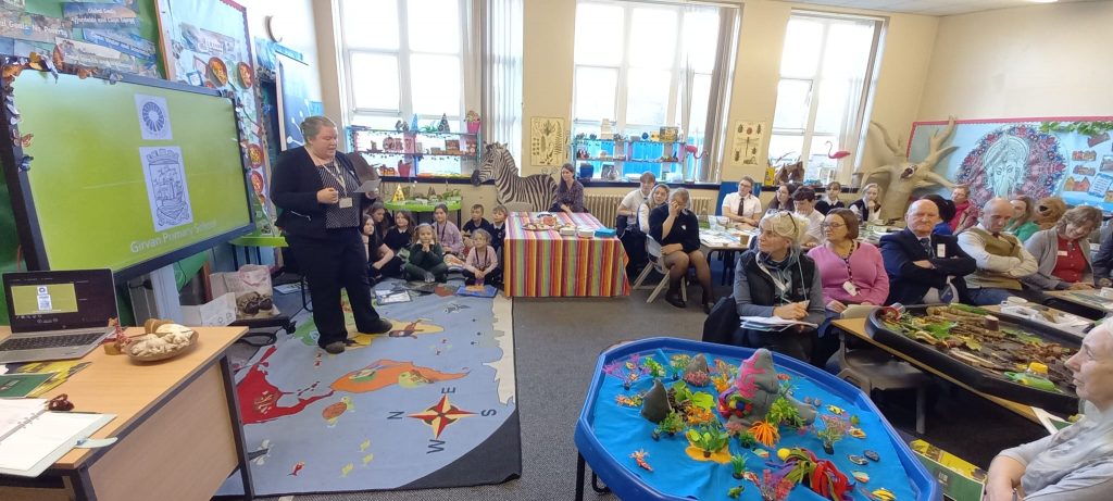 Teacher Sarah Blackie speaking to young learners and invited guests at the Learning for Sustainability Toolkit launch at Girvan Primary School