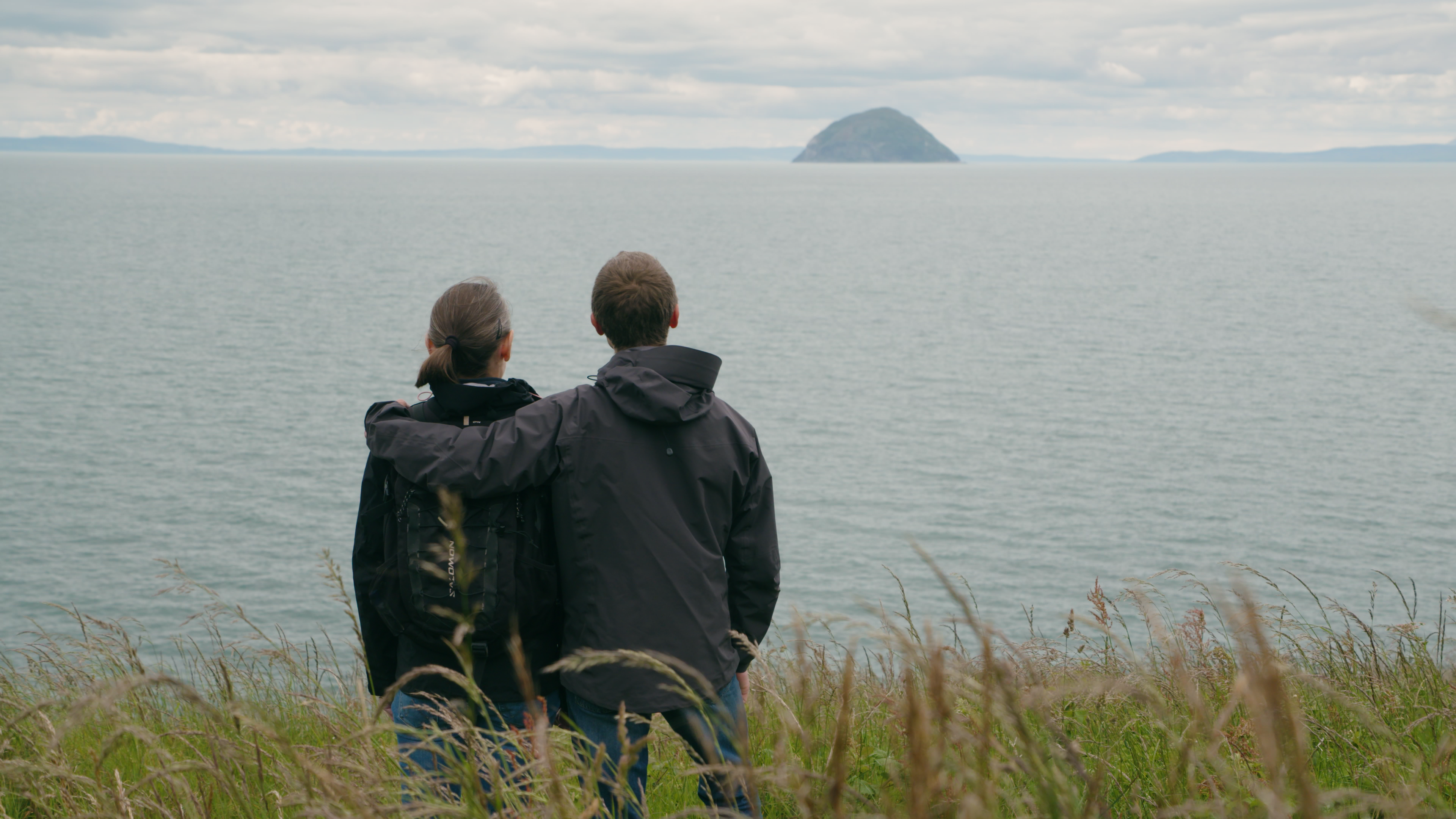 Couple looking out to sea, towards Ailsa Craig.